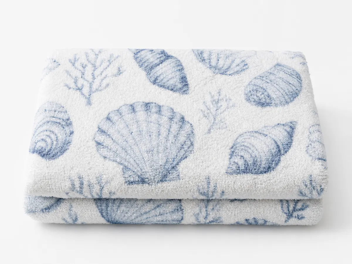 DTG fabric printing sample — plush cotton terry bath towel with delicate seashell pattern