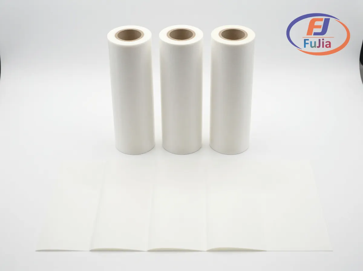 Various DTF printer paper formats showing A4 sheets and rolls of PET transfer film